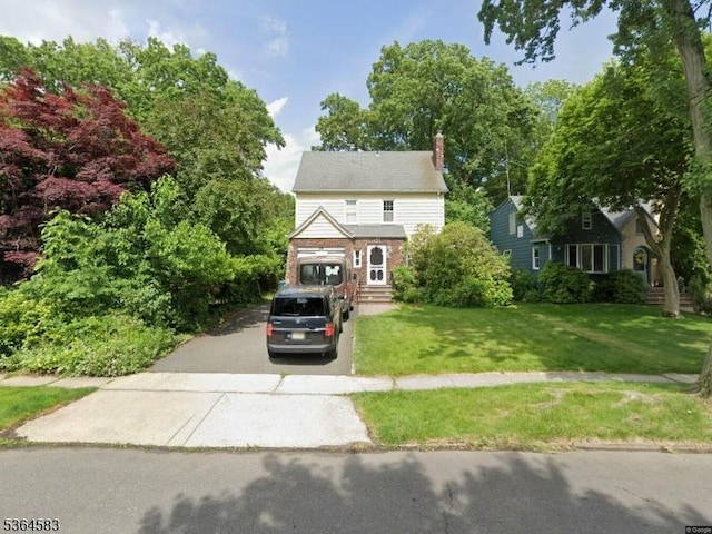 18 Lasalle Ave, Cranford Twp, NJ 07016 - view of front of home with asphalt driveway, a chimney, a front yard, and brick siding