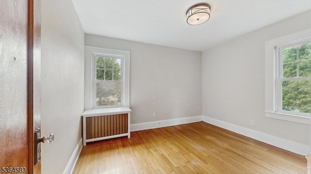 18 Lasalle Ave, Cranford Twp, NJ 07016 - empty room with radiator heating unit, healthy amount of natural light, and light wood-style floors