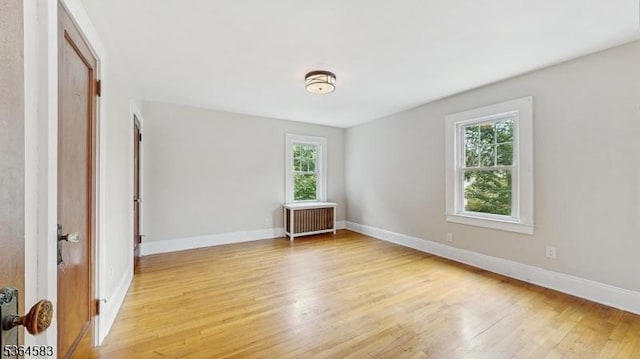 18 Lasalle Ave, Cranford Twp, NJ 07016 - unfurnished bedroom with radiator, multiple windows, and light wood-style floors