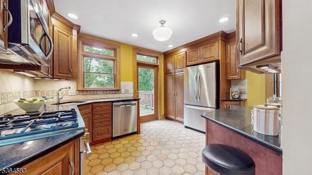 18 Lasalle Ave, Cranford Twp, NJ 07016 - kitchen featuring appliances with stainless steel finishes, decorative backsplash, recessed lighting, dark stone countertops, and brown cabinetry