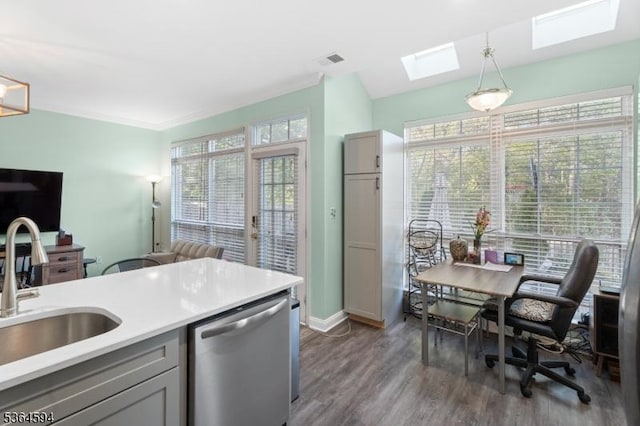 54 Magellan Way, Franklin Twp, NJ 08823 - kitchen with stainless steel dishwasher, a skylight, wood finished floors, pendant lighting, and light countertops
