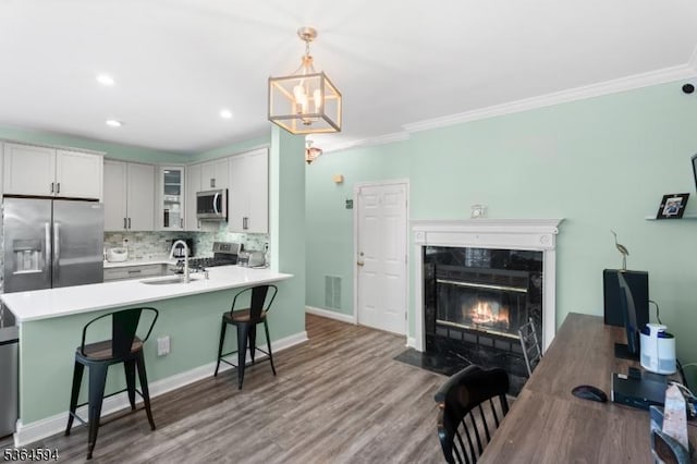54 Magellan Way, Franklin Twp, NJ 08823 - kitchen with stainless steel appliances, a kitchen breakfast bar, tasteful backsplash, a peninsula, and glass insert cabinets
