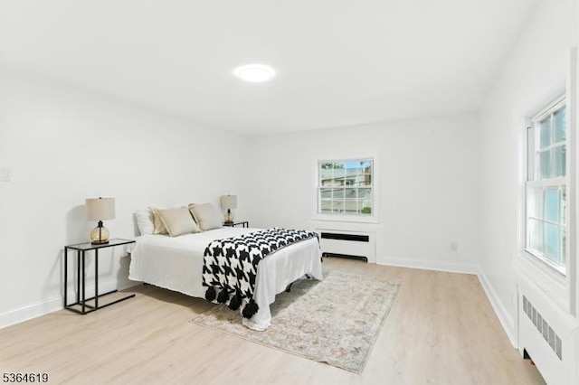28-30 Reynolds Pl, Newark City, NJ 07106 - bedroom with radiator, multiple windows, and light wood-type flooring