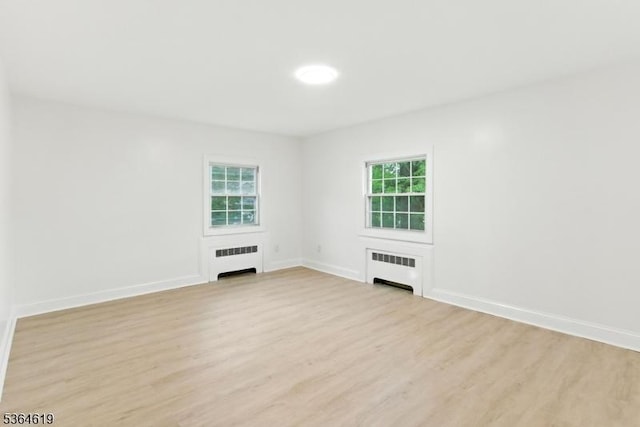28-30 Reynolds Pl, Newark City, NJ 07106 - spare room featuring radiator heating unit, light wood-type flooring, and plenty of natural light