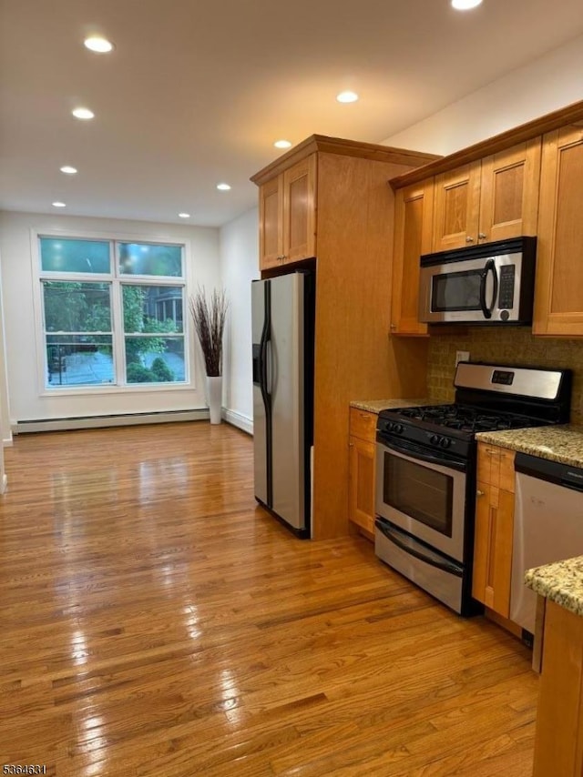 720 Boulevard, Weehawken Twp., NJ 07086 - kitchen with stainless steel appliances, a baseboard radiator, light stone counters, recessed lighting, and light wood-style floors
