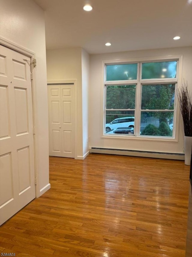 720 Boulevard, Weehawken Twp., NJ 07086 - empty room featuring a baseboard heating unit, wood finished floors, and recessed lighting