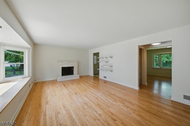 89 Fieldcrest Rd, Parsippany-Troy Hills Twp, NJ 07054 - unfurnished living room with light wood-style flooring and a brick fireplace