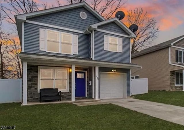 250 E 9th Ave, Roselle Boro, NJ 07203 - view of front facade with driveway, a garage, and stone siding
