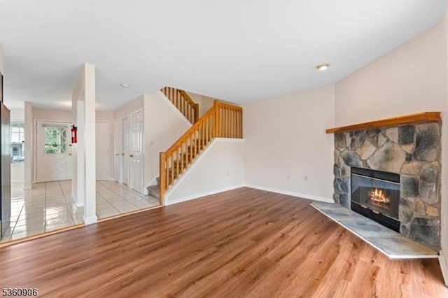26 Allison Ct, South Brunswick Twp, NJ 08852 - unfurnished living room featuring wood finished floors, a stone fireplace, and stairs
