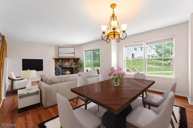 26 Allison Ct, South Brunswick Twp, NJ 08852 - dining area with a chandelier, a fireplace, and wood finished floors