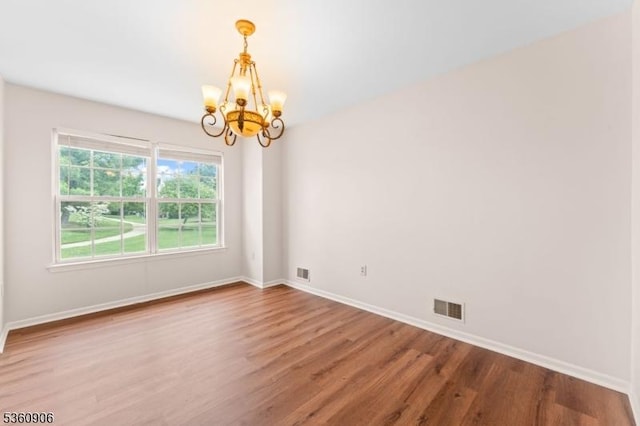 26 Allison Ct, South Brunswick Twp, NJ 08852 - empty room featuring a chandelier and wood finished floors