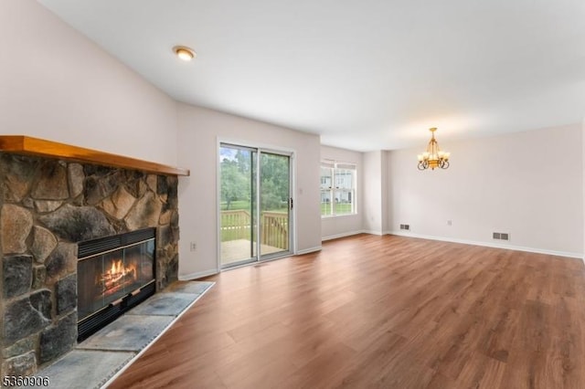 26 Allison Ct, South Brunswick Twp, NJ 08852 - unfurnished living room with a fireplace, wood finished floors, and a chandelier