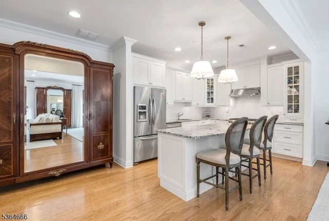 19 Whitney Farm Pl, Morris Twp, NJ 07960 - kitchen featuring stainless steel fridge, under cabinet range hood, glass insert cabinets, a kitchen breakfast bar, and light stone counters