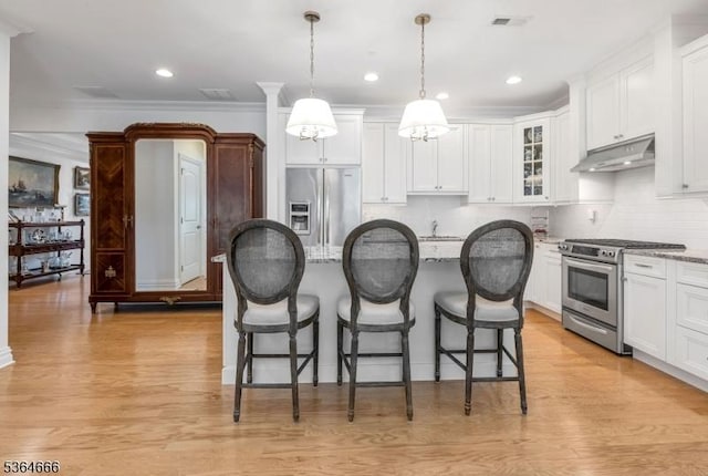 19 Whitney Farm Pl, Morris Twp, NJ 07960 - kitchen featuring stainless steel appliances, under cabinet range hood, a breakfast bar, a center island, and crown molding