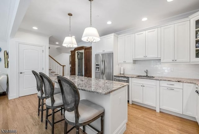 19 Whitney Farm Pl, Morris Twp, NJ 07960 - kitchen with stainless steel appliances, a kitchen island, a kitchen breakfast bar, white cabinets, and glass insert cabinets