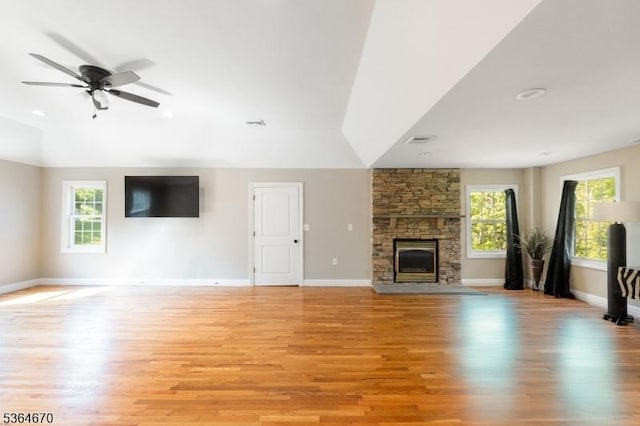 56 Rainbow Hill Rd, East Amwell Twp, NJ 08822 - unfurnished living room featuring healthy amount of natural light, light wood-type flooring, a stone fireplace, and vaulted ceiling