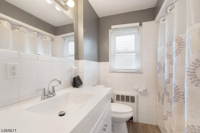 608 Faitoute Ave, Roselle Park Boro, NJ 07204 - bathroom with tile walls, radiator heating unit, vanity, plenty of natural light, and curtained shower