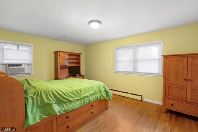 608 Faitoute Ave, Roselle Park Boro, NJ 07204 - bedroom with a baseboard heating unit, cooling unit, and light wood-style floors
