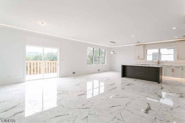 17 Mountain Ave, Mahwah Twp, NJ 07430 - unfurnished living room with plenty of natural light, recessed lighting, and light marble finish flooring