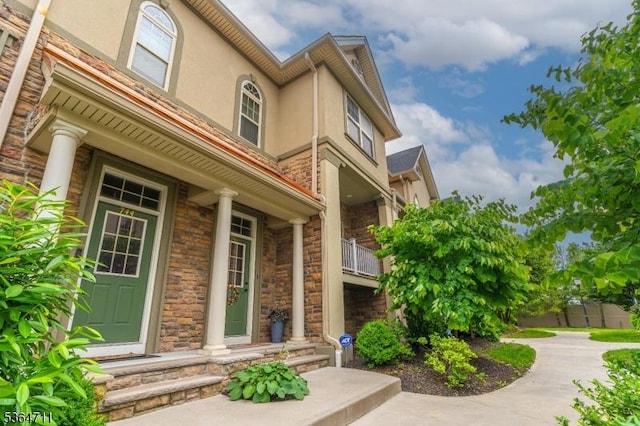 746 Green Ln, Union Twp, NJ 07083 - view of exterior entry with stucco siding, stone siding, and covered porch