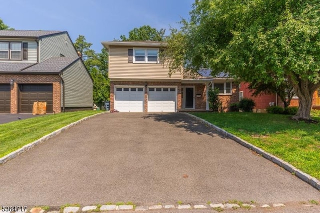 96 Reinhold Ter, Union Twp, NJ 07083 - view of front of property featuring brick siding, a garage, driveway, and a front yard