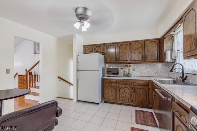 96 Reinhold Ter, Union Twp, NJ 07083 - kitchen with freestanding refrigerator, stainless steel dishwasher, a ceiling fan, decorative backsplash, and light countertops
