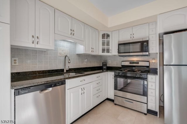 147 Nottingham Sq, Washington Twp, NJ 07840 - kitchen featuring appliances with stainless steel finishes, dark stone counters, white cabinets, and tasteful backsplash