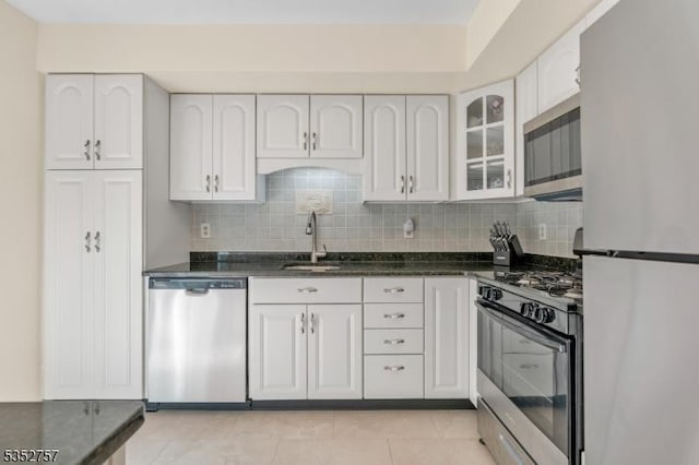 147 Nottingham Sq, Washington Twp, NJ 07840 - kitchen with stainless steel appliances, white cabinets, tasteful backsplash, and glass insert cabinets