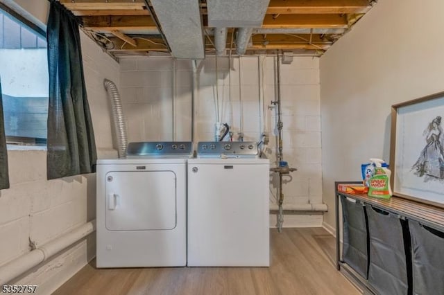 147 Nottingham Sq, Washington Twp, NJ 07840 - laundry room featuring separate washer and dryer, light wood-type flooring, and concrete block wall