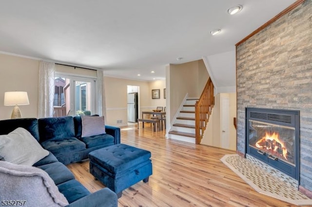 147 Nottingham Sq, Washington Twp, NJ 07840 - living area with light wood-type flooring, a fireplace, ornamental molding, stairway, and recessed lighting