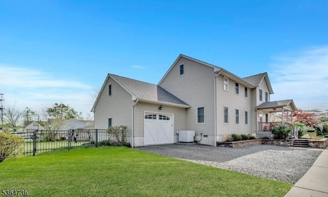 15 Parker St, East Brunswick Twp, NJ 08816 - view of home's exterior with a garage and gravel driveway
