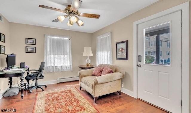 15 Parker St, East Brunswick Twp, NJ 08816 - office area with baseboard heating, wood finished floors, and a ceiling fan
