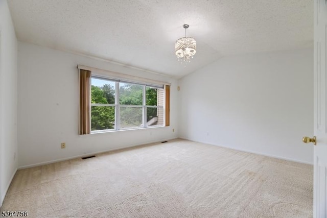 44 Treat Ln, East Brunswick Twp, NJ 08816 - carpeted empty room featuring a chandelier, lofted ceiling, and a textured ceiling