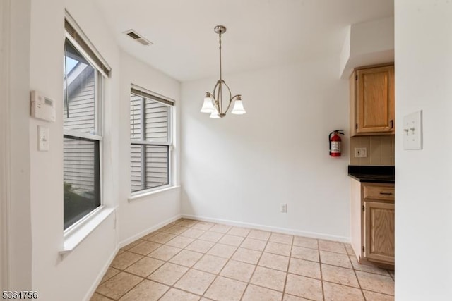 44 Treat Ln, East Brunswick Twp, NJ 08816 - unfurnished dining area featuring a chandelier and light tile patterned flooring