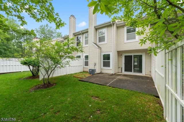 44 Treat Ln, East Brunswick Twp, NJ 08816 - rear view of house with a chimney and a patio area