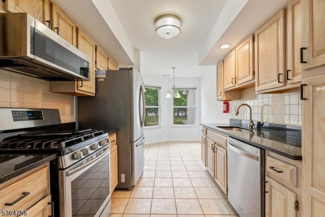 44 Treat Ln, East Brunswick Twp, NJ 08816 - kitchen with appliances with stainless steel finishes, light brown cabinetry, tasteful backsplash, light tile patterned floors, and decorative light fixtures