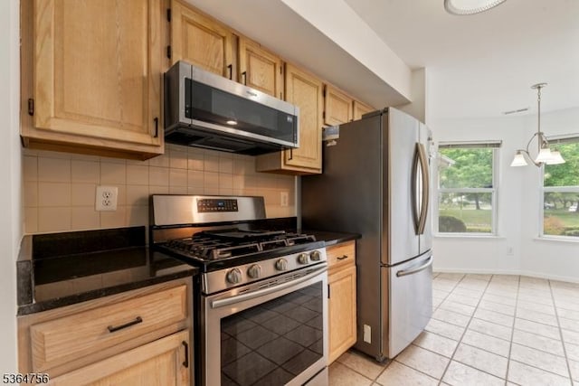 44 Treat Ln, East Brunswick Twp, NJ 08816 - kitchen featuring appliances with stainless steel finishes, dark countertops, backsplash, light tile patterned floors, and hanging light fixtures