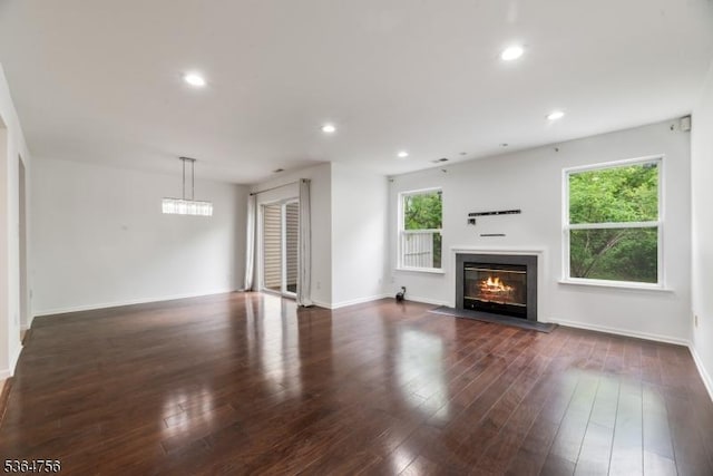 44 Treat Ln, East Brunswick Twp, NJ 08816 - unfurnished living room featuring a glass covered fireplace, dark wood-style floors, and recessed lighting