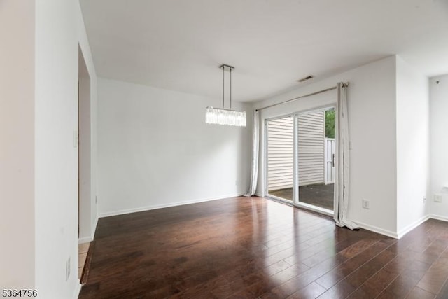 44 Treat Ln, East Brunswick Twp, NJ 08816 - empty room featuring dark wood-style flooring and a chandelier