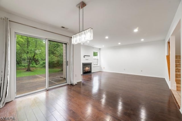 44 Treat Ln, East Brunswick Twp, NJ 08816 - unfurnished living room with hardwood / wood-style floors, a fireplace with flush hearth, recessed lighting, and a chandelier