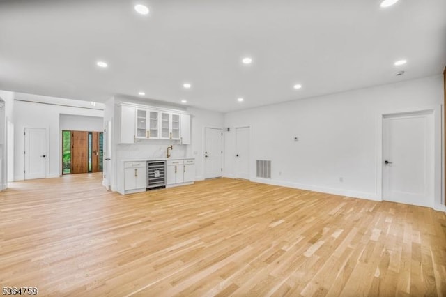 332 Springfield Ave, Westfield Town, NJ 07090 - unfurnished living room featuring wine cooler, bar area, light wood-style floors, and recessed lighting