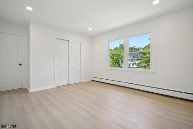 500 Sioux Ave, Parsippany-Troy Hills Twp, NJ 07034 - unfurnished bedroom featuring a baseboard heating unit, light wood-style flooring, recessed lighting, and a closet