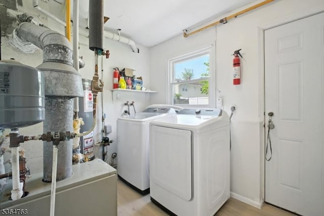 500 Sioux Ave, Parsippany-Troy Hills Twp, NJ 07034 - washroom featuring washing machine and clothes dryer, light wood finished floors, water heater, and a heating unit