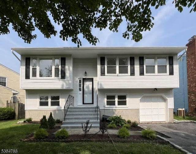 500 Sioux Ave, Parsippany-Troy Hills Twp, NJ 07034 - raised ranch featuring a garage, asphalt driveway, and entry steps