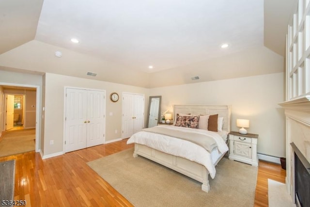 6 Anna Rose Ct, Bloomingdale Boro, NJ 07403 - bedroom with a fireplace with flush hearth, two closets, light wood-style flooring, recessed lighting, and vaulted ceiling