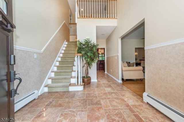 6 Anna Rose Ct, Bloomingdale Boro, NJ 07403 - entrance foyer featuring a baseboard radiator, a towering ceiling, stairs, and stone finish floors