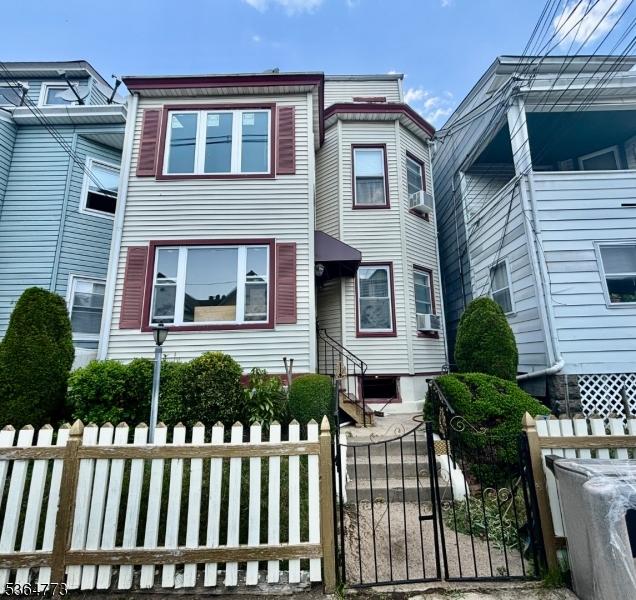 202 Kearney St, Paterson City, NJ 07522 - multi unit property featuring a fenced front yard, a gate, and cooling unit