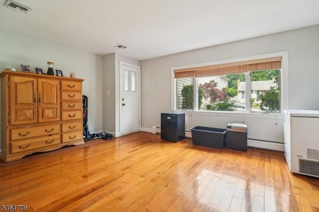 458 Midland Ave, Pompton Lakes Boro, NJ 07442 - living area with a baseboard heating unit and light wood-style flooring