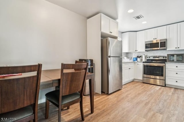 458 Midland Ave, Pompton Lakes Boro, NJ 07442 - kitchen with appliances with stainless steel finishes, decorative backsplash, white cabinetry, light wood-type flooring, and recessed lighting