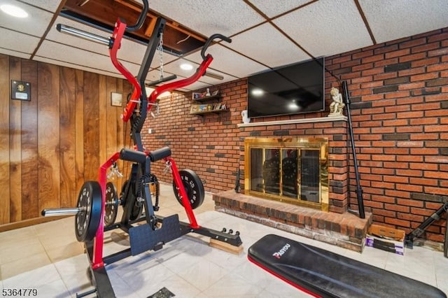 458 Midland Ave, Pompton Lakes Boro, NJ 07442 - workout room featuring brick wall, a fireplace, tile patterned floors, and wooden walls